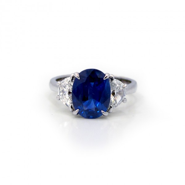 This is a picture of a 3 Stone Oval Blue Sapphire and Half Moon Diamond Ring
