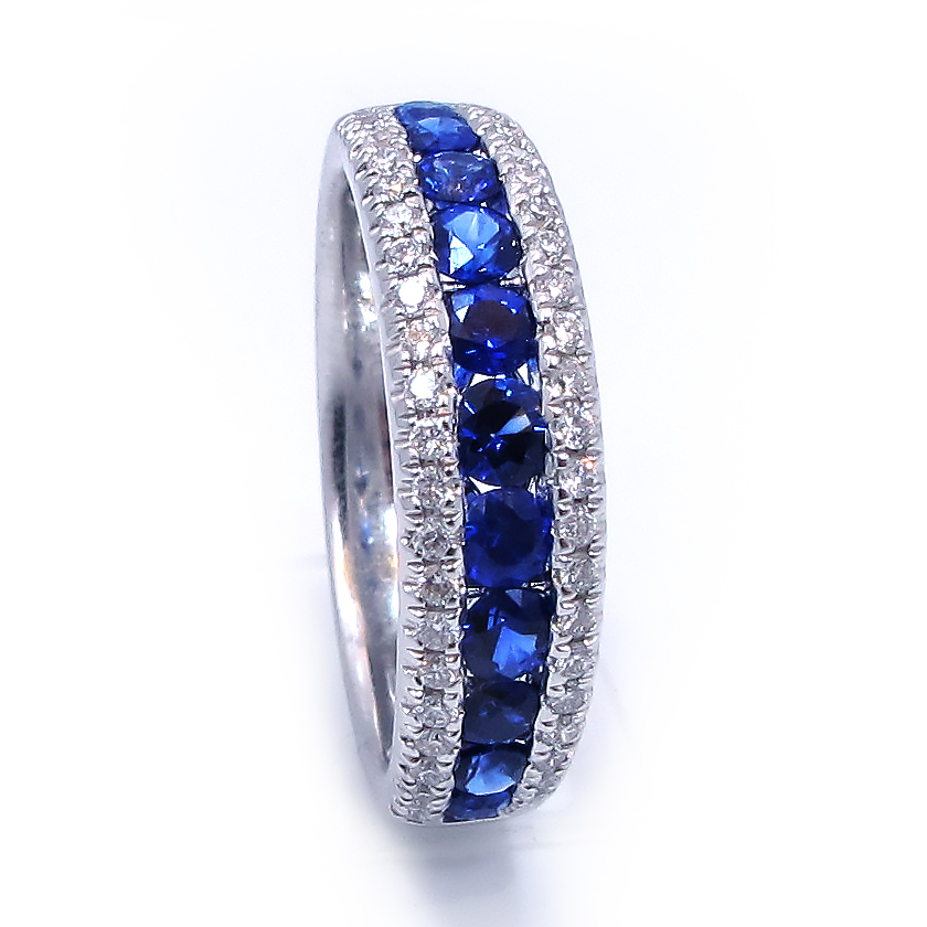 This is a picture of a Blue Sapphire and Diamond Ring in 18k White Gold