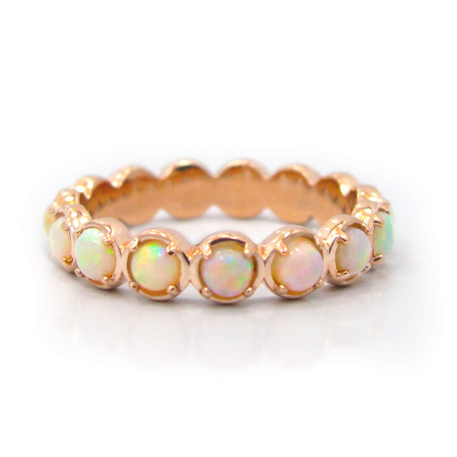 This is a picture of a 14k Rose Gold Opal Eternity Band
