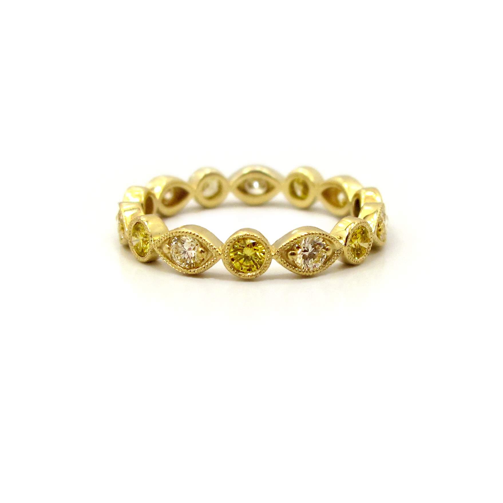 This is a picture of an Alternating Marquise and Round Bezel Fancy Yellow Diamond Eternity Band